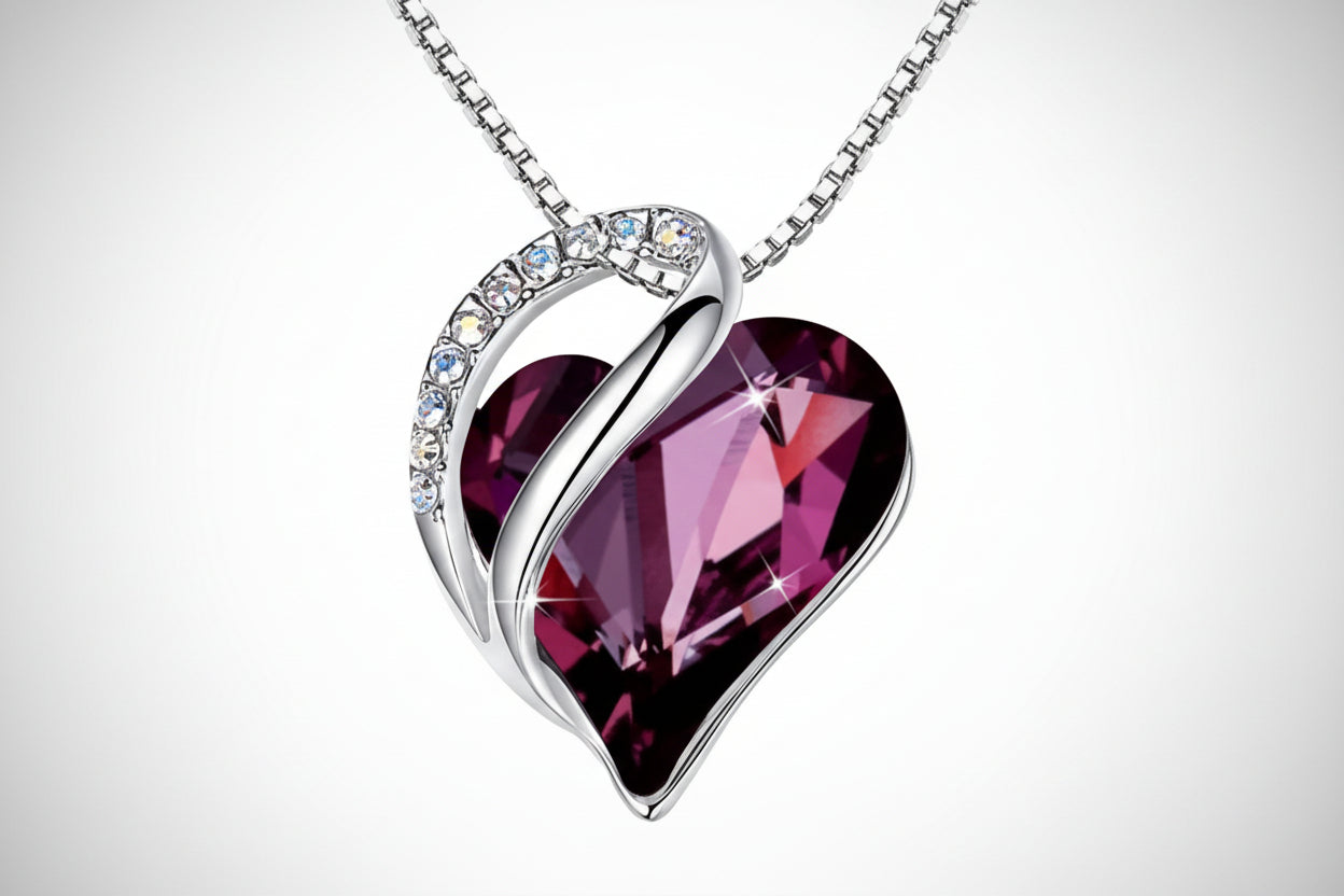 Heart-shaped purple gemstone necklace with silver chain on a white background