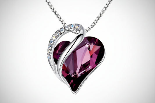 Heart-shaped purple gemstone necklace with silver chain on a white background