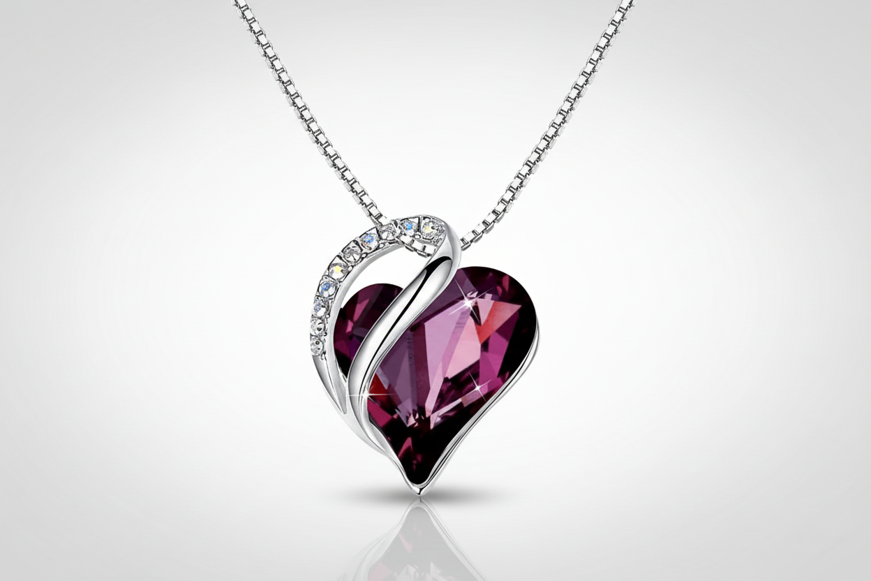 Heart-shaped purple gemstone necklace with silver chain on a white background