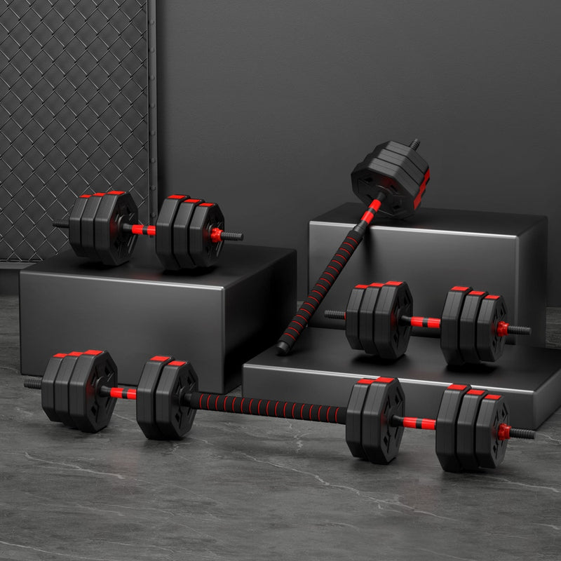 Set of black and red dumbbells on a dark gray surface with a dark background
