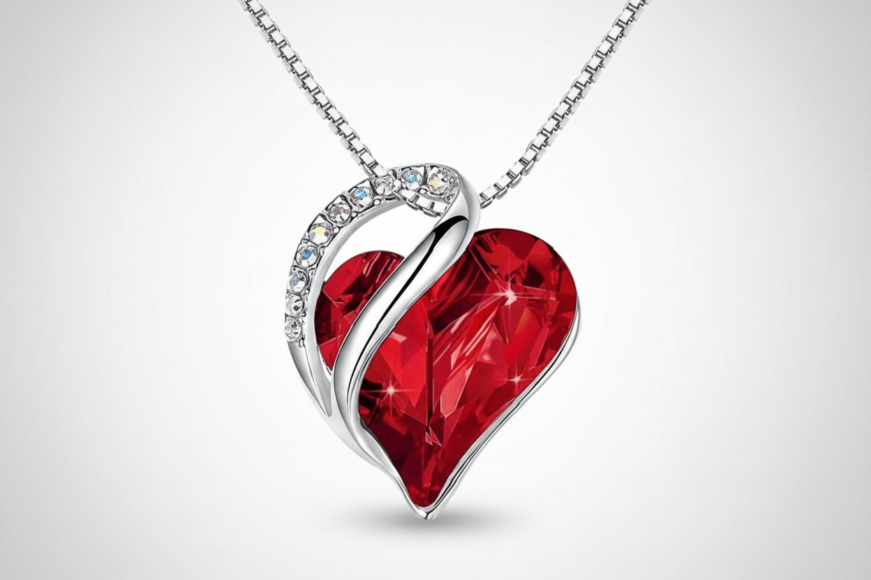 Red heart-shaped pendant with silver chain on a white background