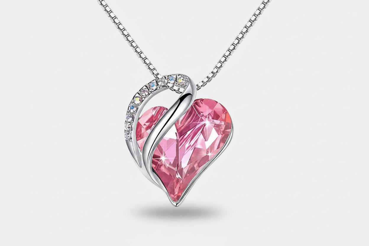 Pink heart-shaped pendant with silver frame on a white background
