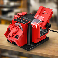 A red and black Giantz multifunctional tool sharpener with various attachments placed on a wooden surface, designed for sharpening different tools such as knives and drills.