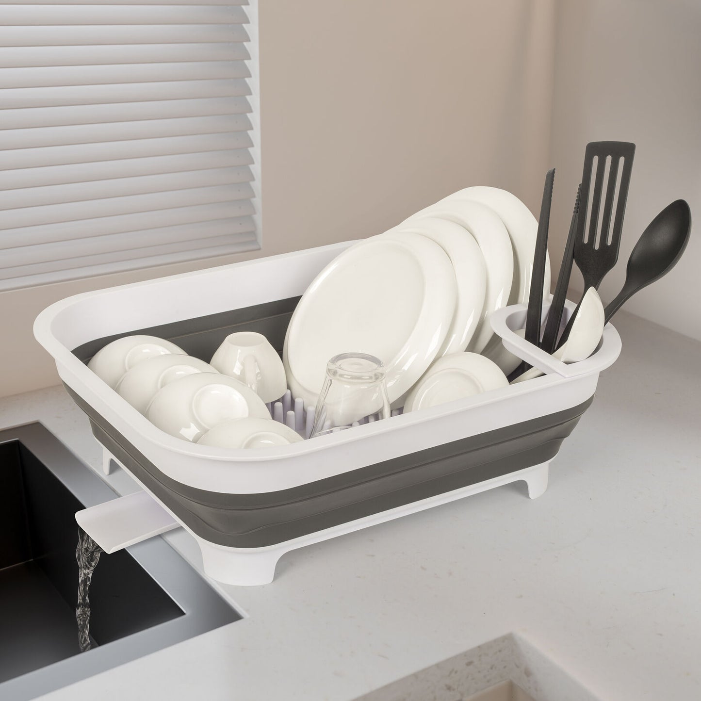Collapsible dish rack with dishes on a kitchen counter